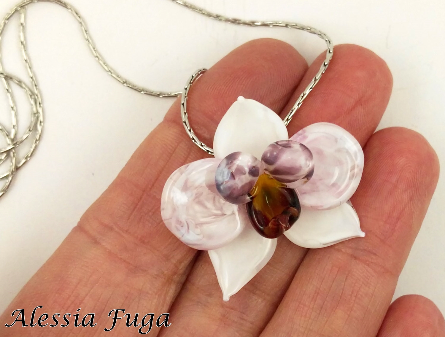 withe and pink orchid pendant in my hand for size reference