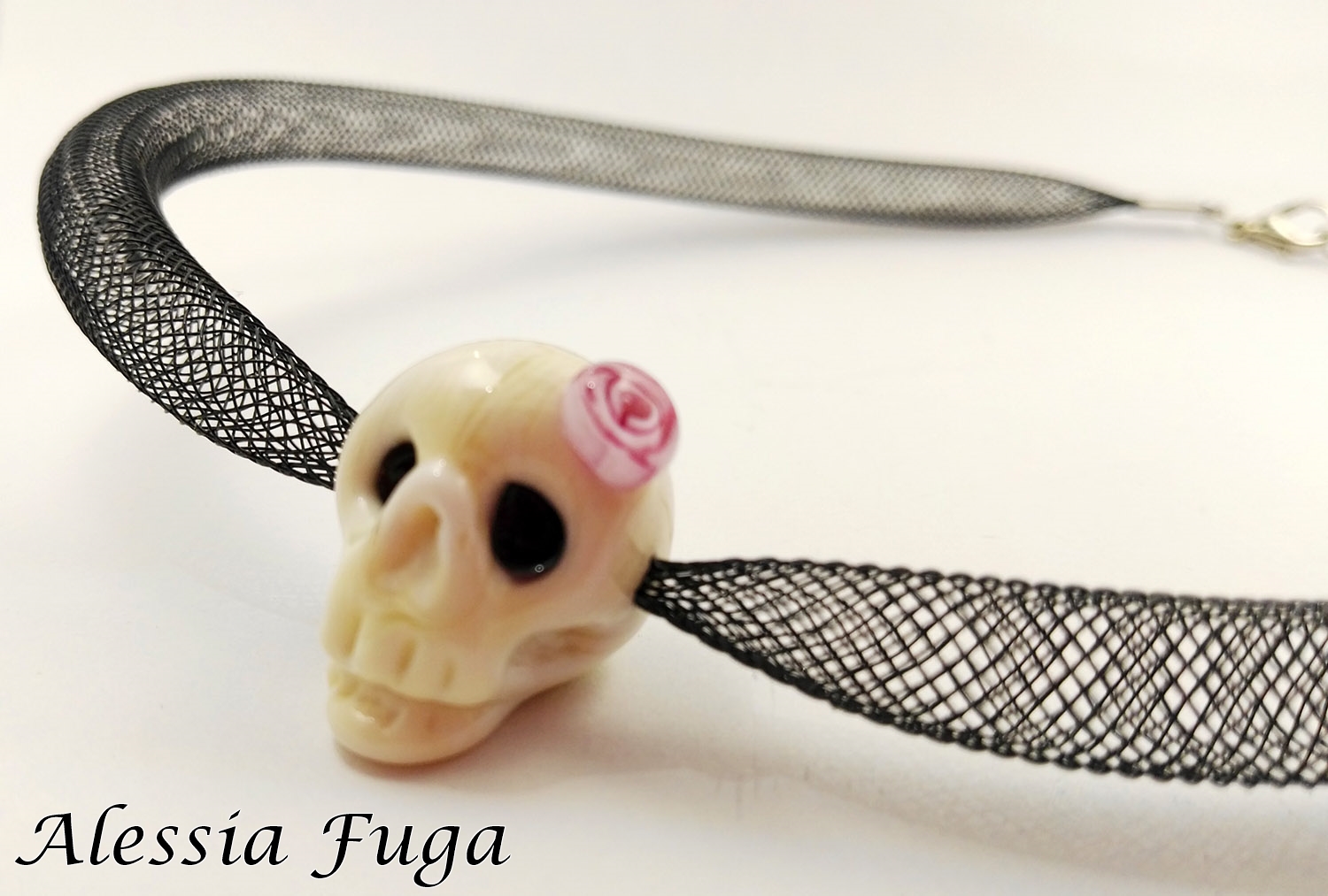 Girly skull with rose murrini on a plastic mesh tube necklace